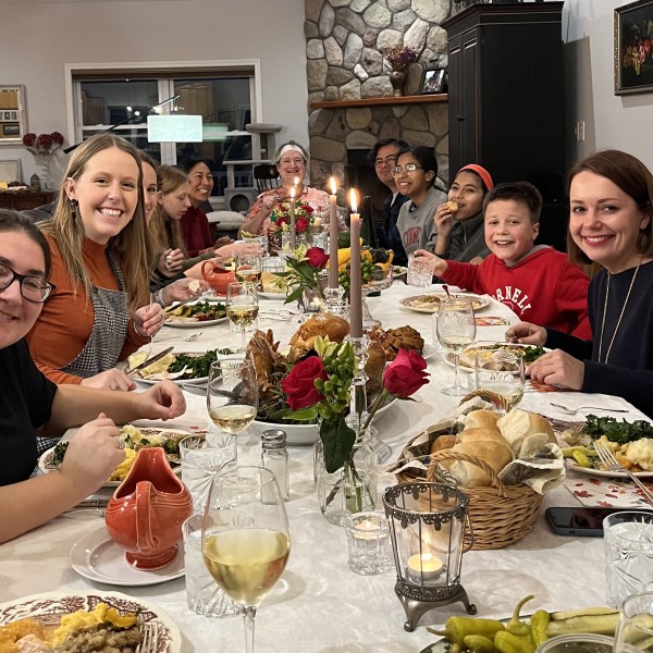 Group sits for Thanksgiving dinner