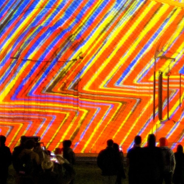 a light show being projected onto the side of the Johnson Museum