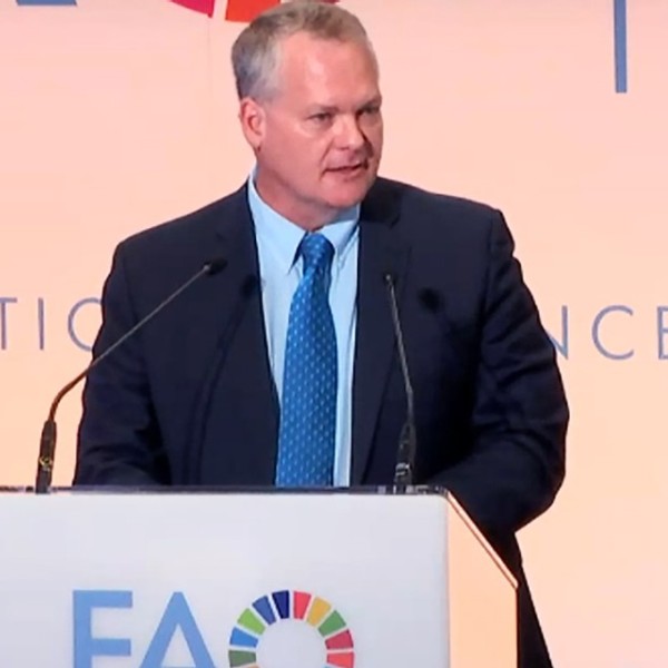 Professor Christopher B. Barrett speaking at a podium.