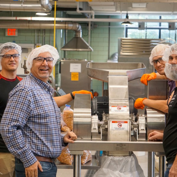 Four men working inside the Cornell Food Venture Center Pilot Plant