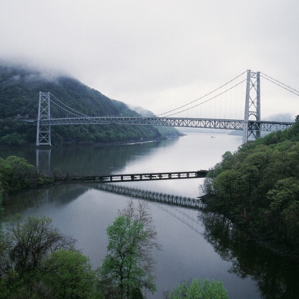 A bridge over a river on a cloudy day.