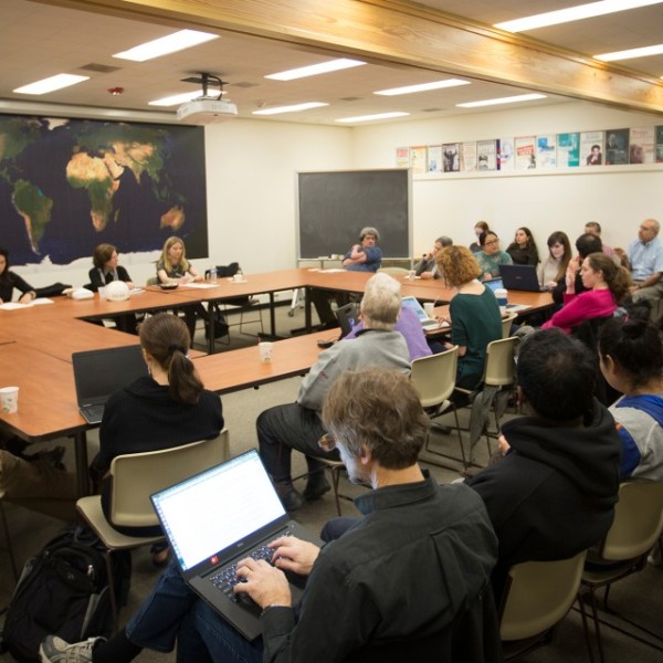 Classroom with students gathered around a roundtable.