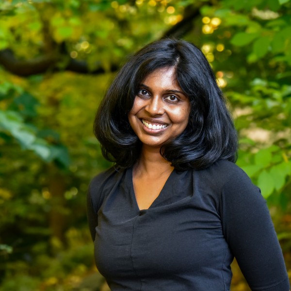 Woman in black shirt smiles at camera