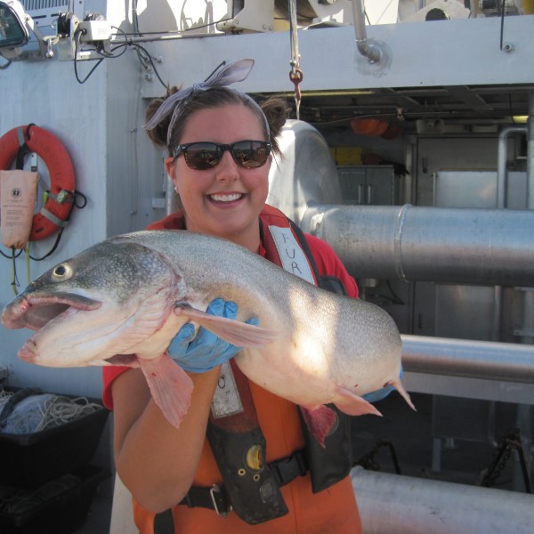 A woman holds a fish