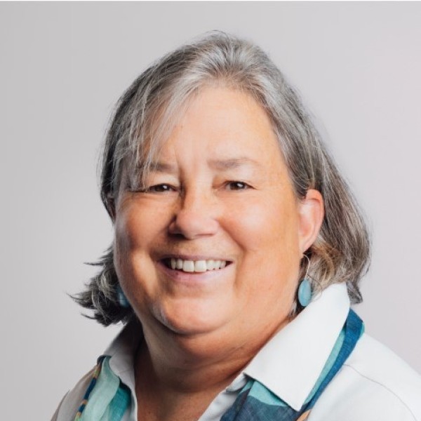 a person with a collared shirt and gray hair