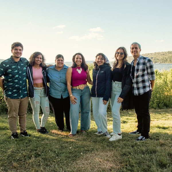A group poses on a lake shore