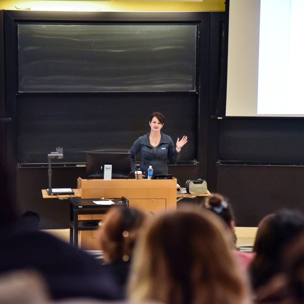 woman lectures to students