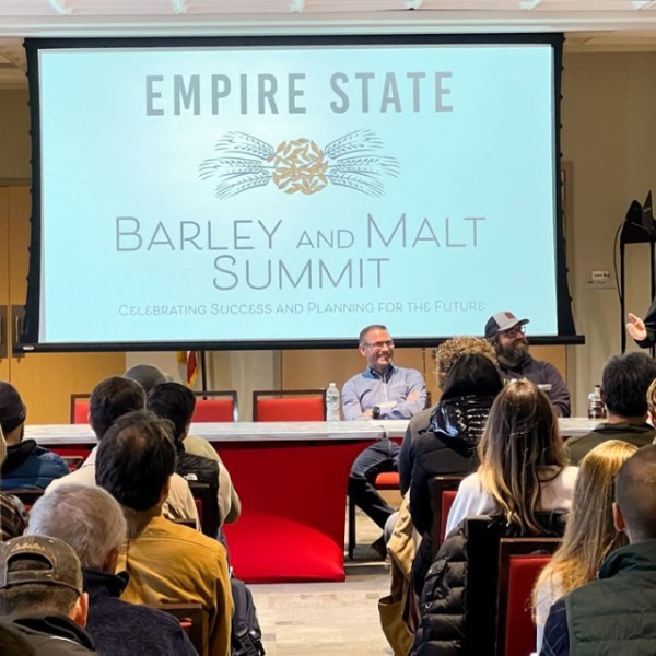 Attendees sit in a ballroom and listen to a presenter at the Empire State Barley and Malt Summit