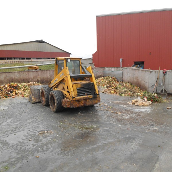 skid loader moves food waste