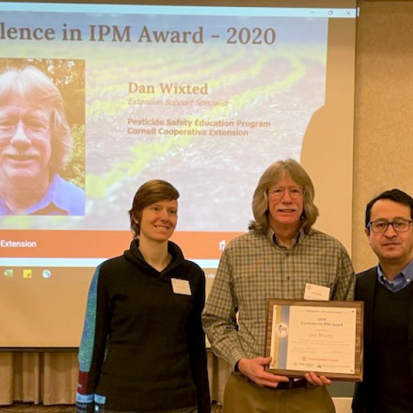award recipient posing with certificate
