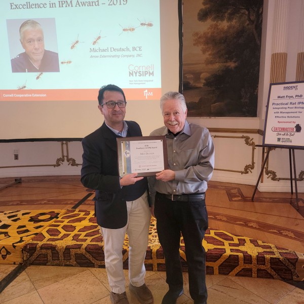 Alejandro Calixto and Mike Deutsch posting with award. 