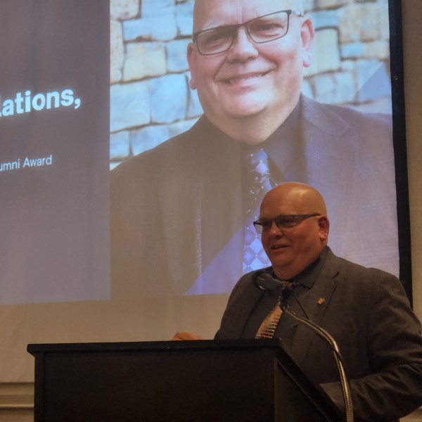 Man receives award on stage