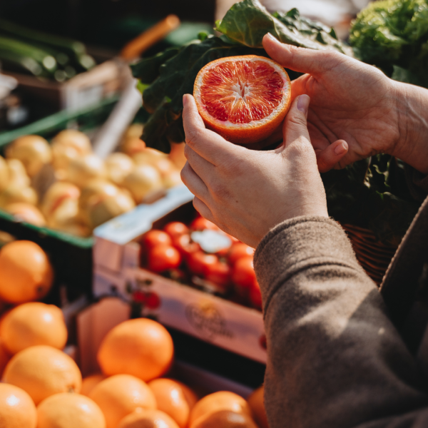 hands holding half an orange