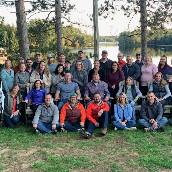 Group poses for photo outside