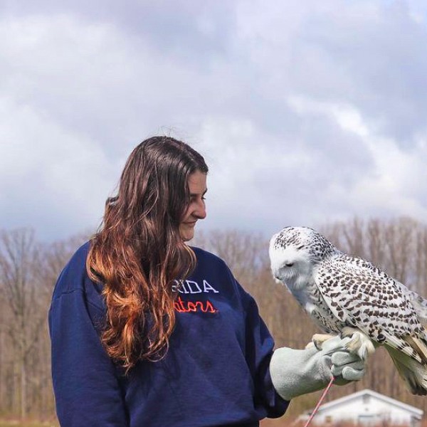 Marin Silverman holds a snowy owl