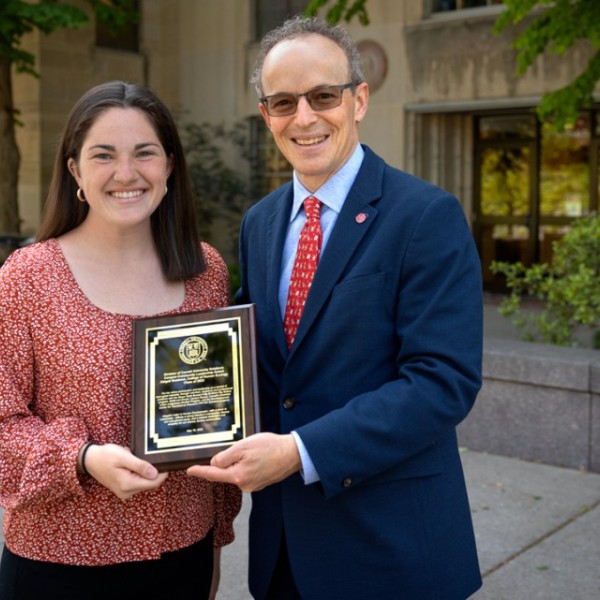 Abigail Boatmun ’23, a student in the College of Human Ecology, receives the 2023 Campus-Community Leadership Award from Joel Malina.