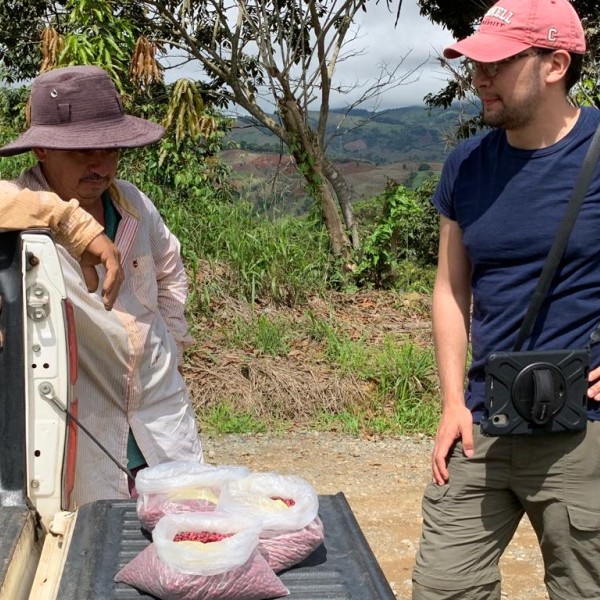 A farmer and Cornell student speak outside