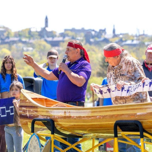 Jake Edwards gives introductory remarks during the canoe dedication ceremony at Cass Park.