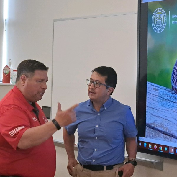 people in front of a spotted lanternfly image having a conversation