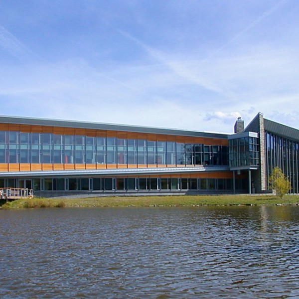 The Cornell Lab of Ornithology with a pond in front of the building