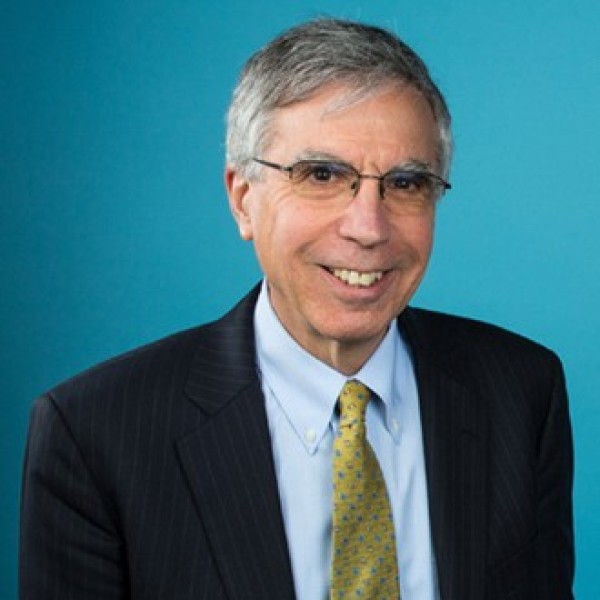 Headshot of Robert Stavins in a suit and a yellow tie.