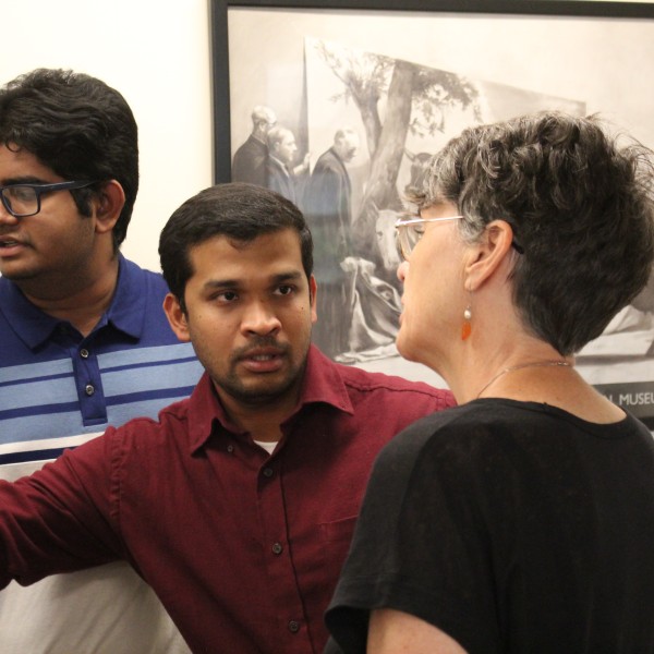 Two people present poster