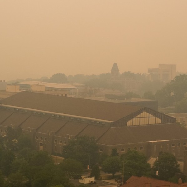 Smoke from wildfires burning in Canada shroud the Sage Hall tower, foreground, and McGraw Tower