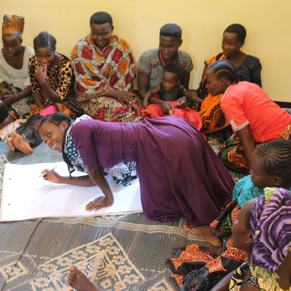 Group draws on poster during a workshop
