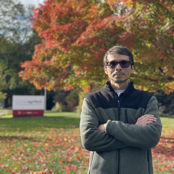 Andres Antolinez stands in front of AgriTech sign