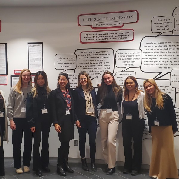 students post with their exhibition behind them