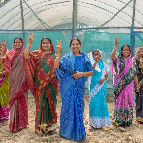 Women entrepreneurs give peace sign