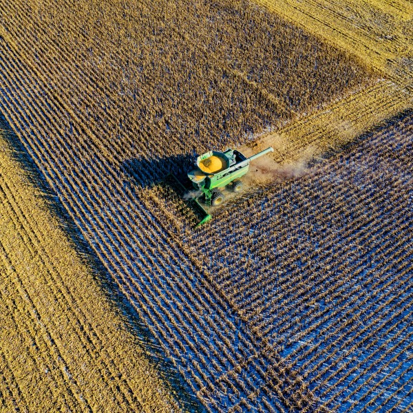 a field being harvested is seen from above