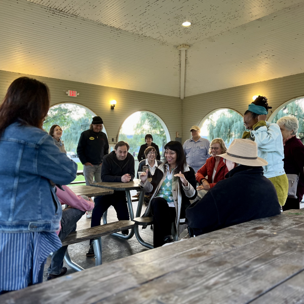 group of people gathered around picnic tables