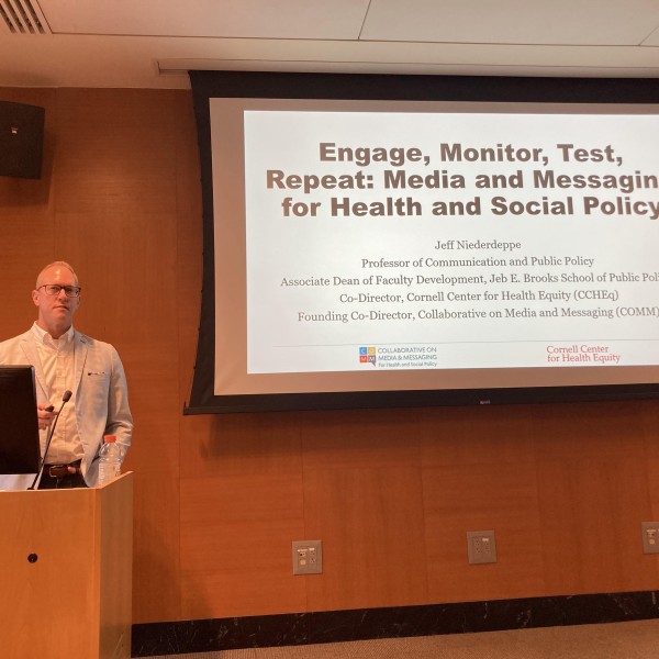 Man in front of screen giving talk