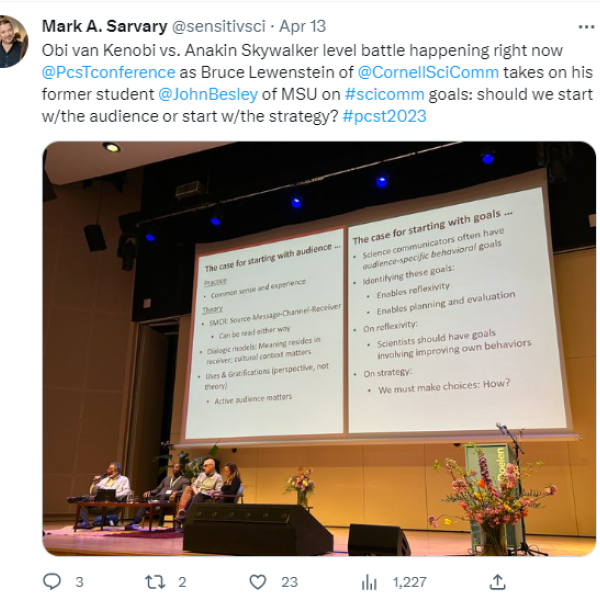 panel of individuals in front of big screen in lecture hall