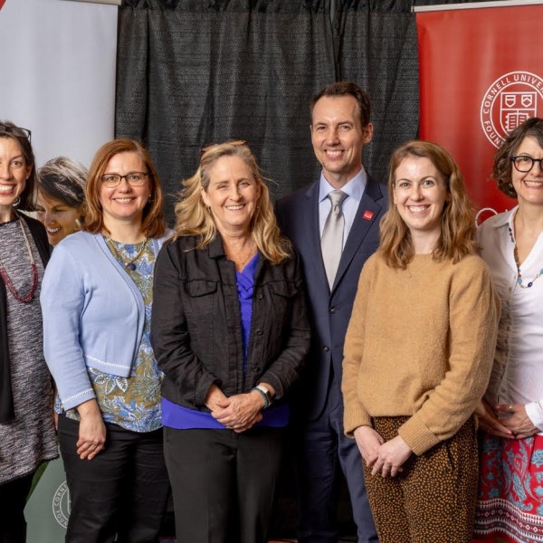 6 individuals standing and smiling