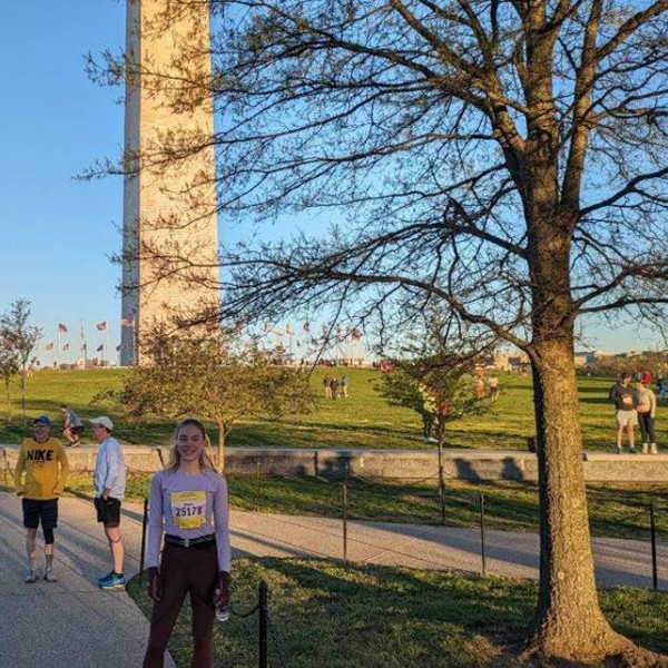 women stands in front of Washington Monument