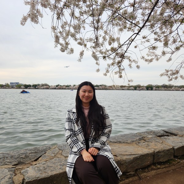 Woman sits by the water