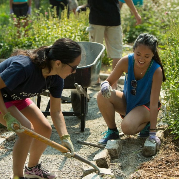 two young women working in a garden