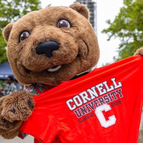 Touchdown the Bear holding a red Cornell tshirt on Ho Plaza