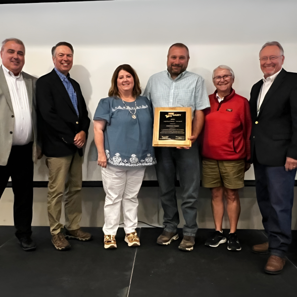 6 people standing with an award