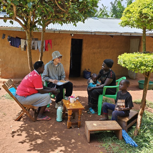 Four people sit in circle and converse