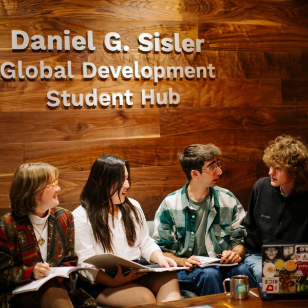 Four students seated in the Daniel G. Sisler Global Development Student Hub