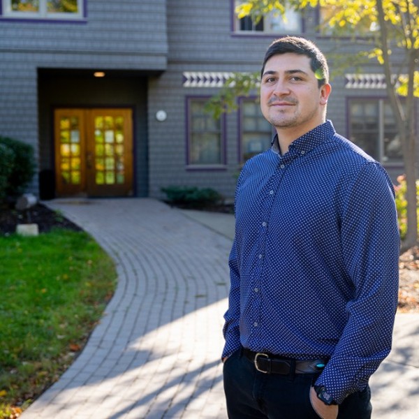 Michael Charles ’16, a citizen of the Navajo Nation and assistant professor, outside Akwe:kon, a residence hall devoted to Indigenous cultures, where Charles lived as an undergraduate at Cornell. Photo by Jason Koski. 