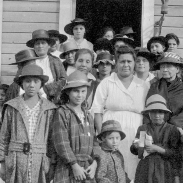 Members of the Onondaga Conservation Club standing in front of Temperance Hall on the Onondaga Nation, circa 1919.