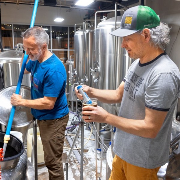 Jamey Tielens, left, and Ben Brotman consult on a recent brewing day at Liquid State Brewing Company. Brotman says the state’s brewers organizations “keep brewers in touch with other breweries and build a sense of camaraderie.” Photo by Jason Koski.