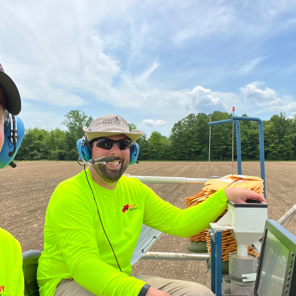 two people on a tractor in a field