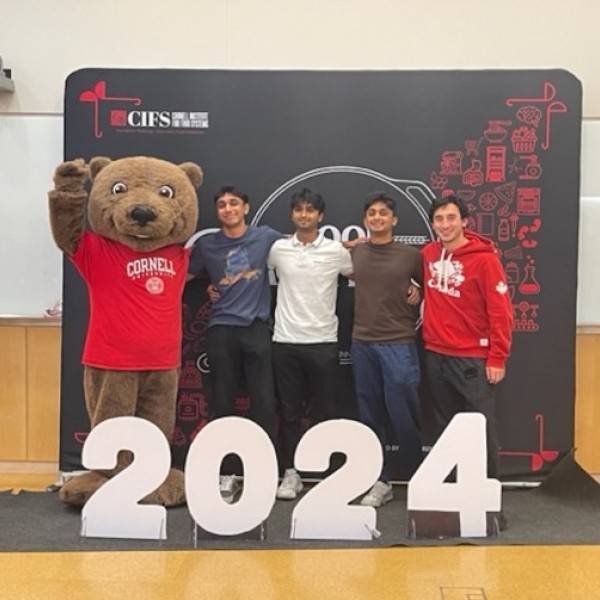 The grand prize winners for the Food Hackathon pose with Touchdown the Bear after the weekend.
