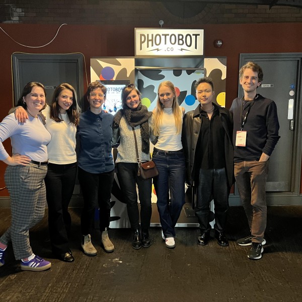 6 individuals stand and pose for a photo