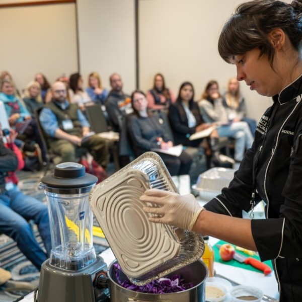 Attendees watch a food preparation presentation at the inaugural New York Farm to School Summit in Syracuse, N.Y.
